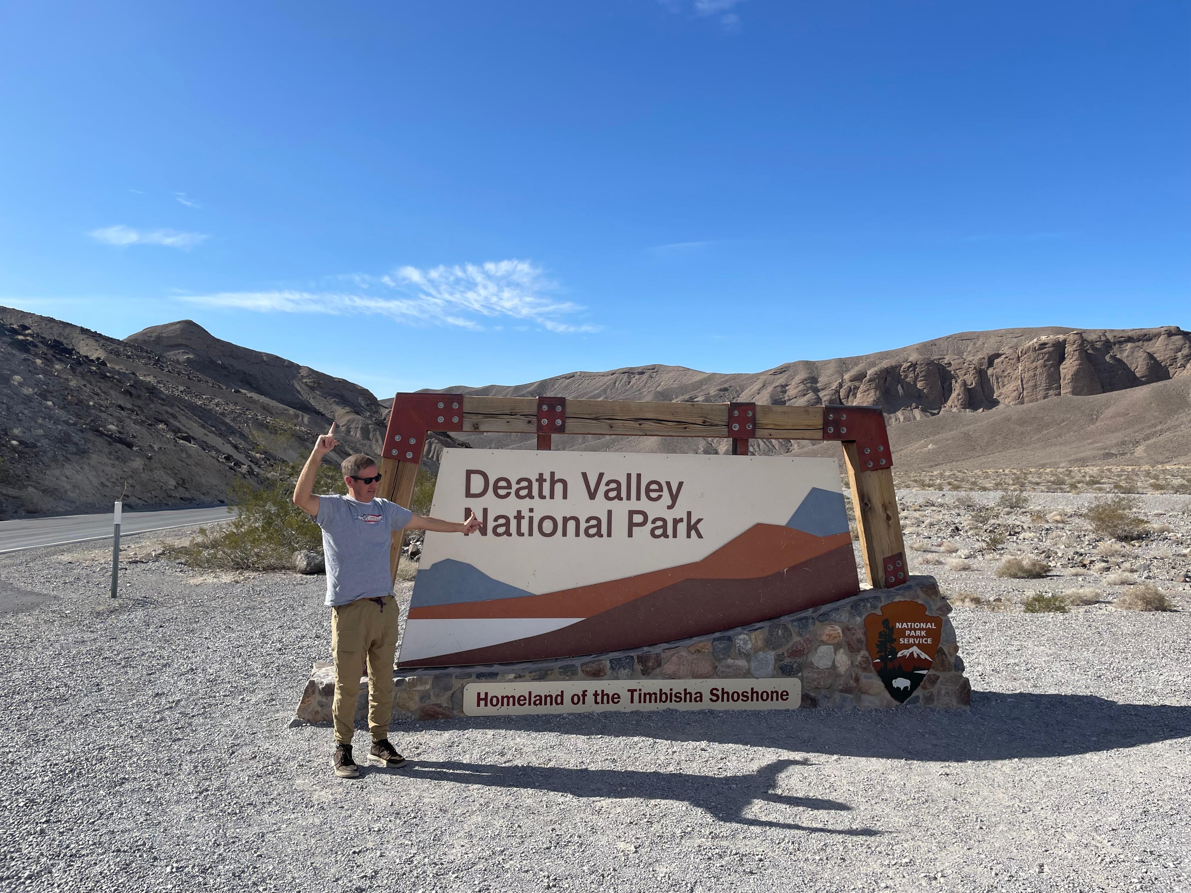 Team member at the Death Valley National Park entrance sign